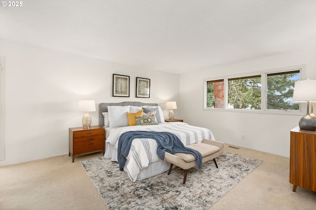 carpeted bedroom featuring visible vents