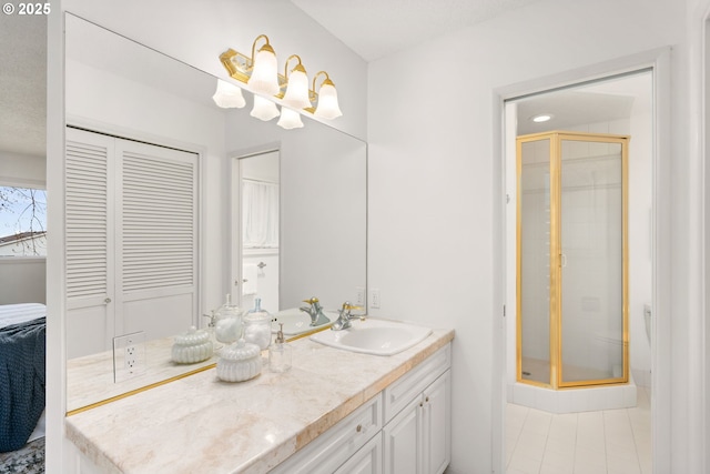 full bathroom featuring vanity, tile patterned floors, a stall shower, and an inviting chandelier