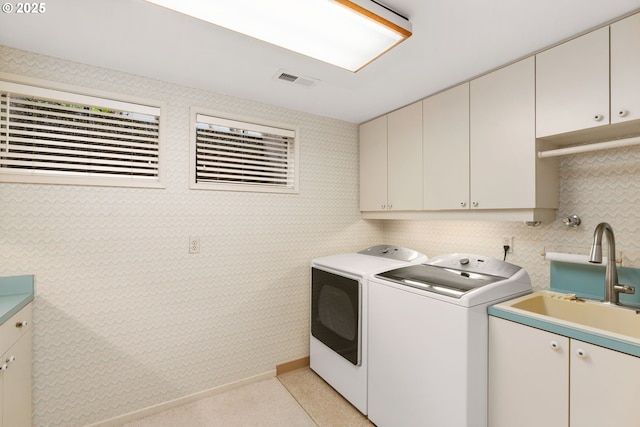 laundry room featuring cabinet space, separate washer and dryer, visible vents, and a sink