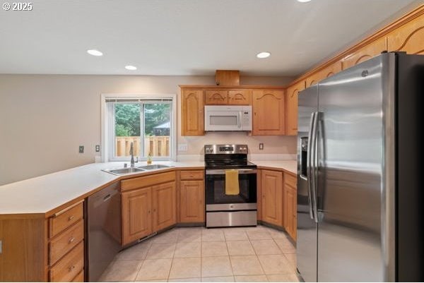 17504 SE 16th Cir, Vancouver, WA 98683 - kitchen featuring appliances with stainless steel finishes, a sink, light countertops, light tile patterned floors, and recessed lighting