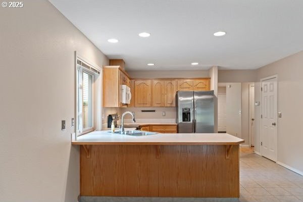 17504 SE 16th Cir, Vancouver, WA 98683 - kitchen with stainless steel fridge, white microwave, a sink, a peninsula, and light countertops