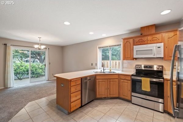 17504 SE 16th Cir, Vancouver, WA 98683 - kitchen featuring stainless steel appliances, a sink, plenty of natural light, light tile patterned floors, and recessed lighting