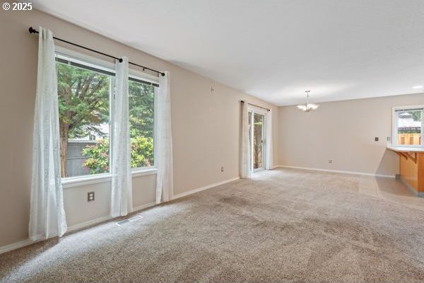 17504 SE 16th Cir, Vancouver, WA 98683 - spare room with a chandelier, baseboards, and light colored carpet