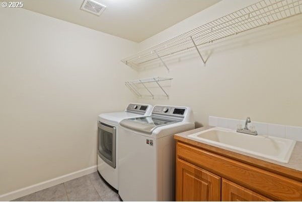 17504 SE 16th Cir, Vancouver, WA 98683 - washroom with washer and clothes dryer, light tile patterned floors, cabinet space, and baseboards