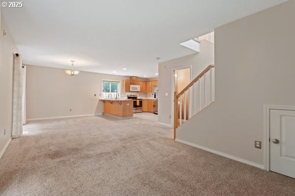 17504 SE 16th Cir, Vancouver, WA 98683 - unfurnished living room featuring a chandelier, light carpet, stairs, baseboards, and recessed lighting