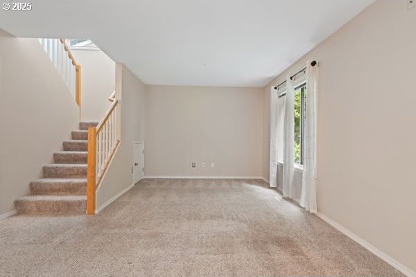 17504 SE 16th Cir, Vancouver, WA 98683 - unfurnished living room featuring stairs, carpet floors, and baseboards
