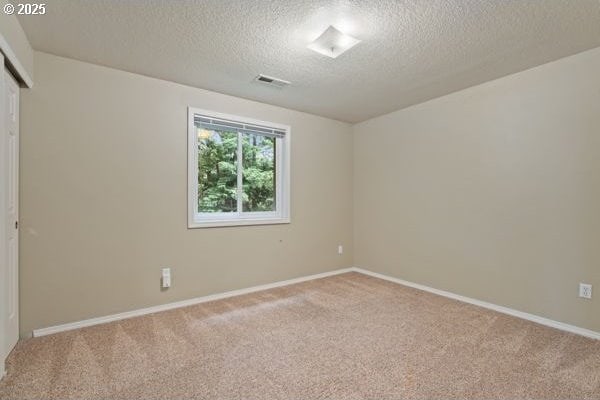 17504 SE 16th Cir, Vancouver, WA 98683 - unfurnished room with a textured ceiling, light carpet, and baseboards