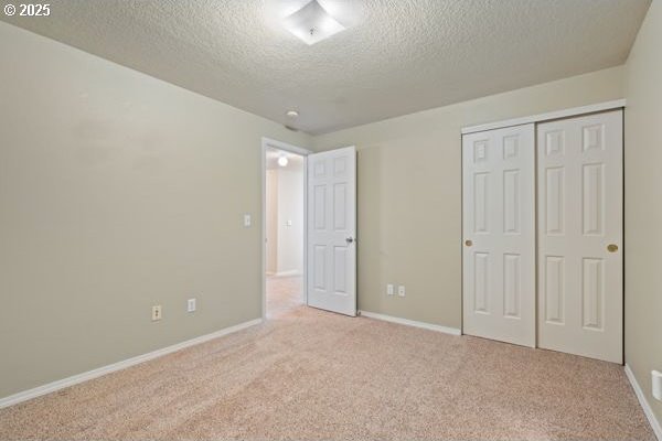 17504 SE 16th Cir, Vancouver, WA 98683 - unfurnished bedroom with a textured ceiling, carpet floors, a closet, and baseboards