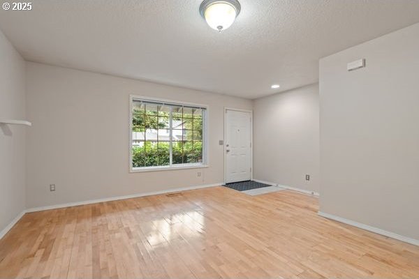 17504 SE 16th Cir, Vancouver, WA 98683 - foyer entrance featuring light wood finished floors, baseboards, and a textured ceiling
