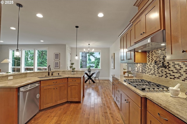 1734 NW Saltzman Rd, Portland, OR 97229 - kitchen with stainless steel appliances, under cabinet range hood, a sink, backsplash, and light wood-style flooring