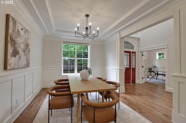 1734 NW Saltzman Rd, Portland, OR 97229 - dining room with plenty of natural light, a raised ceiling, a chandelier, a decorative wall, and hardwood / wood-style floors