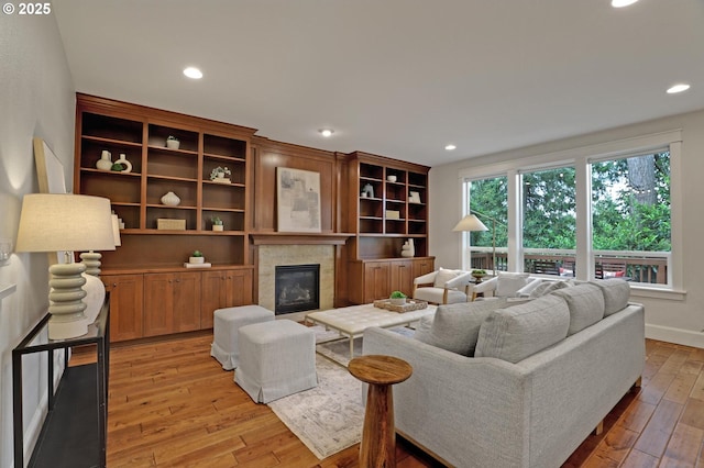 1734 NW Saltzman Rd, Portland, OR 97229 - living area with a glass covered fireplace, light wood-type flooring, recessed lighting, and baseboards