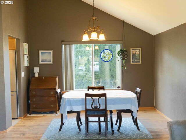 3135 SE 26th St, Gresham, OR 97080 - dining area featuring light wood-type flooring, high vaulted ceiling, and a chandelier