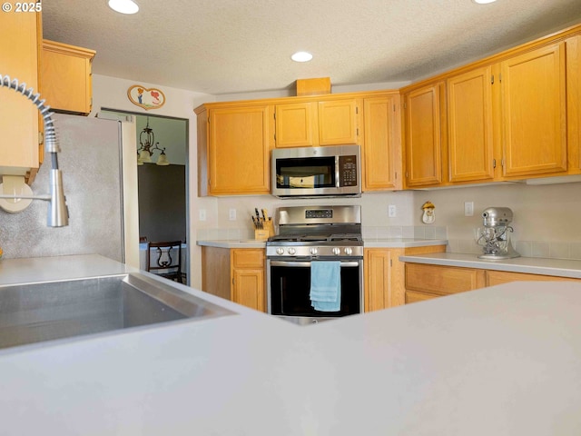 3135 SE 26th St, Gresham, OR 97080 - kitchen featuring appliances with stainless steel finishes, light countertops, recessed lighting, and a textured ceiling