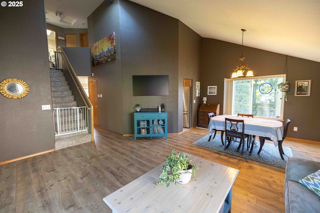 3135 SE 26th St, Gresham, OR 97080 - living room featuring wood finished floors, stairway, high vaulted ceiling, and a chandelier