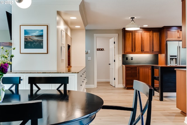 dining room with baseboards, light wood-style floors, and recessed lighting