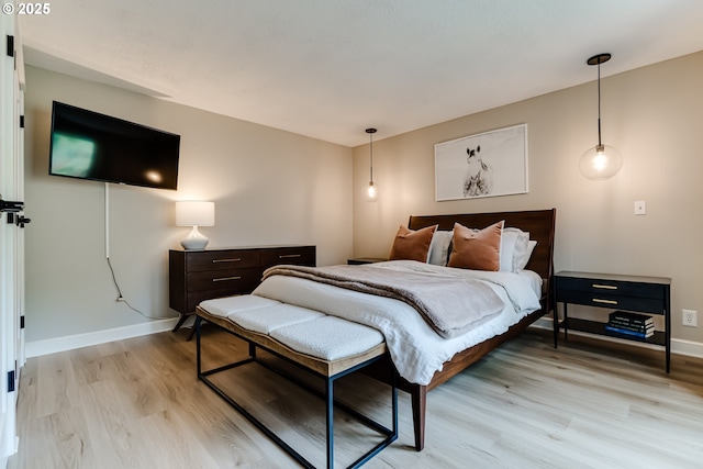 bedroom with baseboards and light wood-type flooring