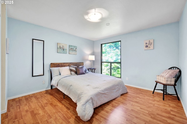 bedroom with baseboards and light wood-style flooring