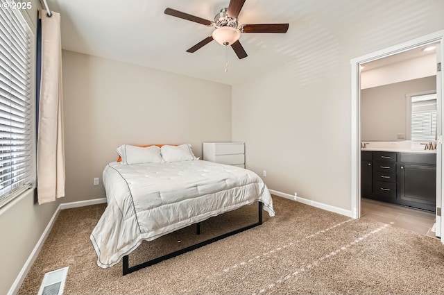 carpeted bedroom with ceiling fan, sink, and connected bathroom