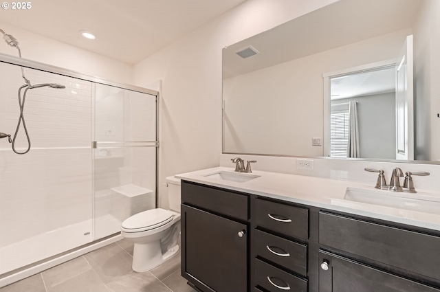 bathroom featuring vanity, toilet, tile patterned floors, and walk in shower