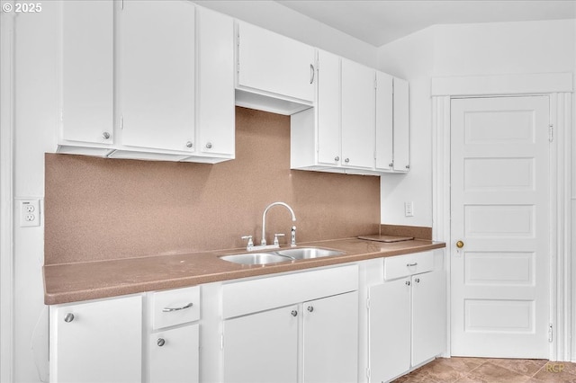kitchen with a sink and white cabinets