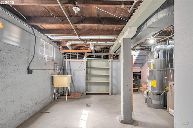 unfinished basement with water heater and a sink