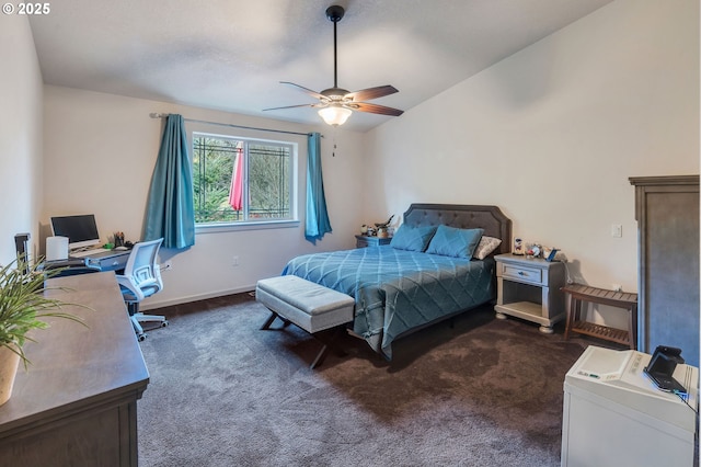 bedroom featuring lofted ceiling, dark carpet, baseboards, and ceiling fan