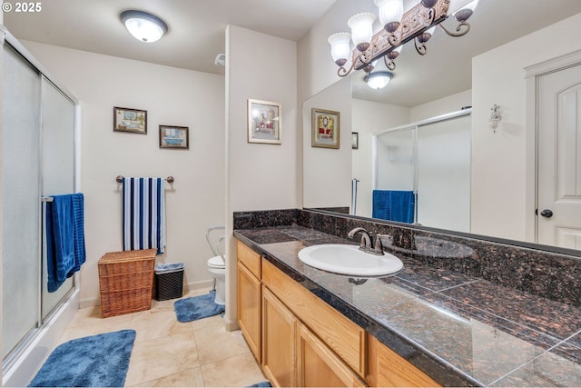 bathroom featuring a shower stall, tile patterned flooring, toilet, and vanity