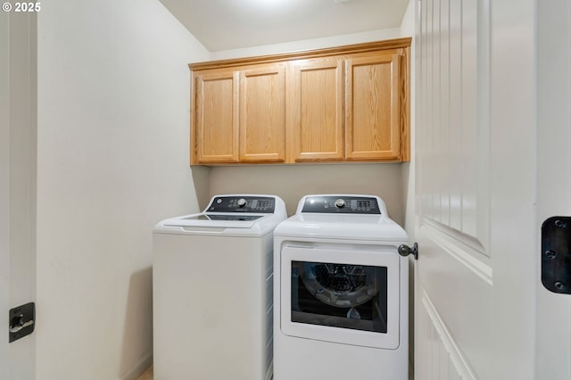 laundry area featuring cabinet space and washer and clothes dryer