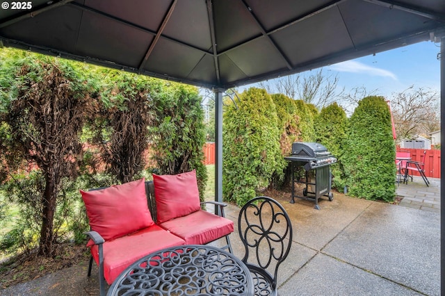 view of patio featuring area for grilling and fence