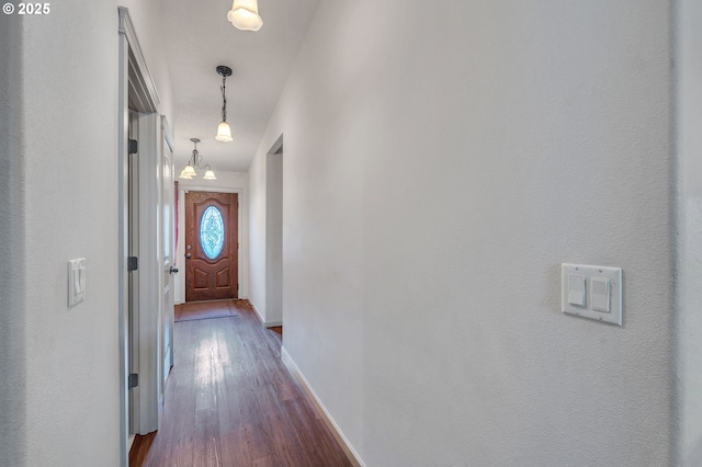 hall with baseboards and dark wood-style flooring