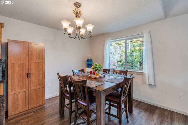 dining space with an inviting chandelier, dark wood finished floors, and baseboards