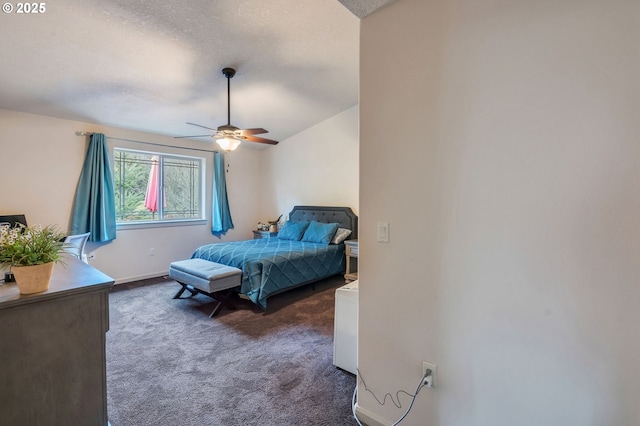 bedroom featuring baseboards, dark carpet, ceiling fan, and a textured ceiling