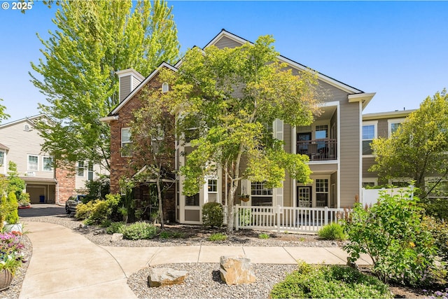 1231 NE Horizon Loop Unit 203, Hillsboro, OR 97124 - view of front of property featuring a porch, brick siding, and a balcony