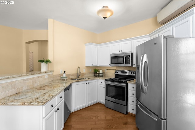 1231 NE Horizon Loop Unit 203, Hillsboro, OR 97124 - kitchen featuring appliances with stainless steel finishes, a sink, a wall unit AC, and white cabinets