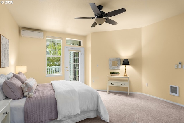 1231 NE Horizon Loop Unit 203, Hillsboro, OR 97124 - carpeted bedroom with a wall mounted AC, access to outside, a ceiling fan, baseboards, and heating unit