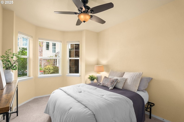 1231 NE Horizon Loop Unit 203, Hillsboro, OR 97124 - bedroom with carpet floors, baseboards, and a ceiling fan