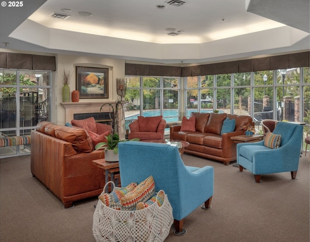 1231 NE Horizon Loop Unit 203, Hillsboro, OR 97124 - living area featuring light colored carpet, a raised ceiling, and a fireplace
