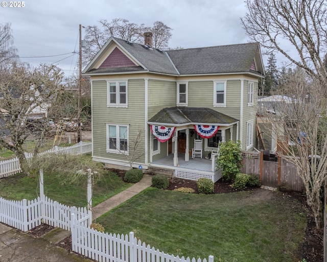 victorian-style house with a porch and a front lawn