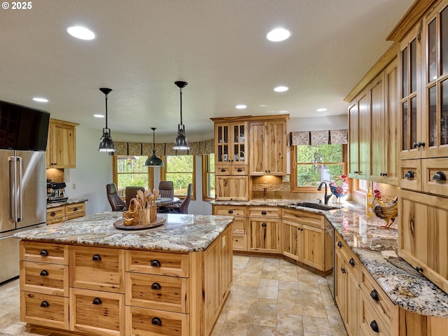 23456 S Schieffer Rd, Colton, OR 97017 - kitchen featuring high end refrigerator, a sink, a kitchen island, recessed lighting, and light stone counters