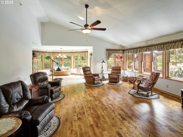 23456 S Schieffer Rd, Colton, OR 97017 - living room with wood-type flooring, a chandelier, healthy amount of natural light, ceiling fan, and high vaulted ceiling