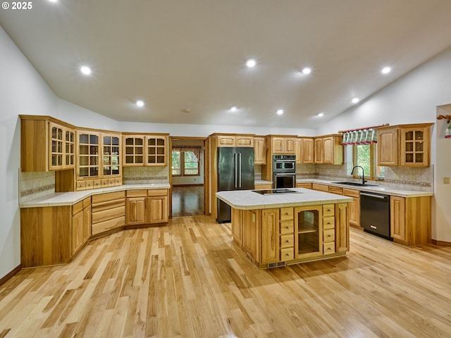 23456 S Schieffer Rd, Colton, OR 97017 - kitchen with black appliances, vaulted ceiling, backsplash, light wood finished floors, and a kitchen island