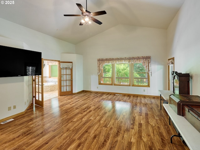 23456 S Schieffer Rd, Colton, OR 97017 - unfurnished living room featuring wood finished floors, french doors, ceiling fan, high vaulted ceiling, and baseboards