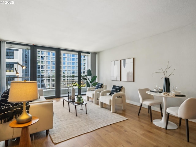 255 SW Harrison St Unit 9C, Portland, OR 97201 - living room featuring wood finished floors, expansive windows, and baseboards