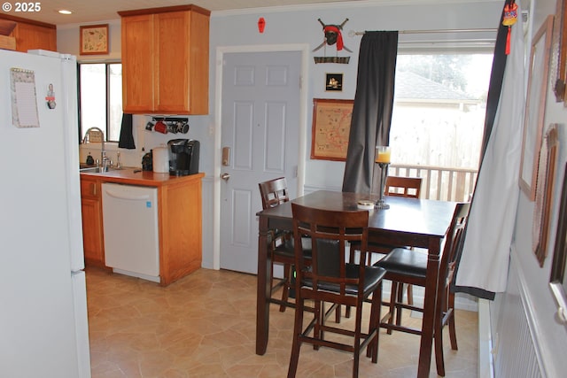 dining area featuring ornamental molding and sink