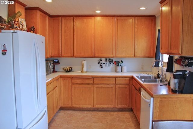 kitchen featuring white appliances and sink