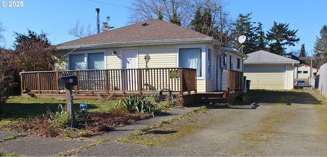 exterior space featuring a garage and an outbuilding