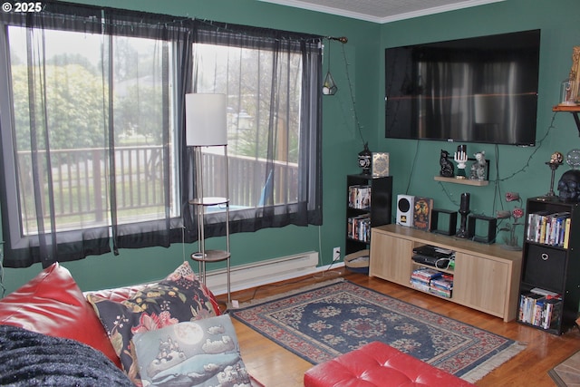 living room featuring crown molding, wood-type flooring, and baseboard heating