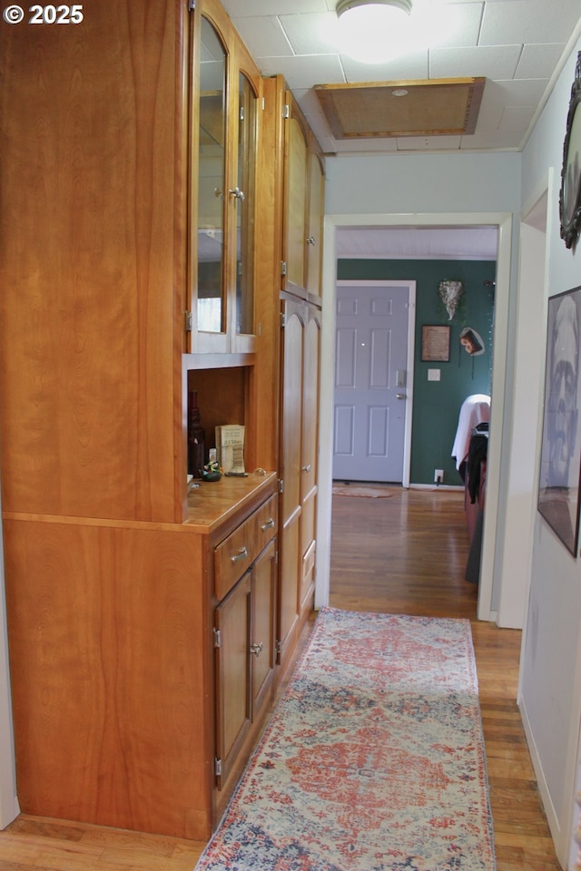 hallway with light hardwood / wood-style floors