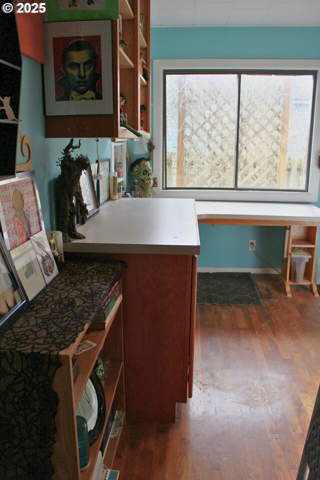 kitchen featuring dark hardwood / wood-style flooring and built in desk